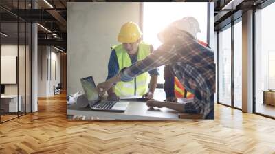 engineer team planning and discussing about construction building on table in working site Wall mural