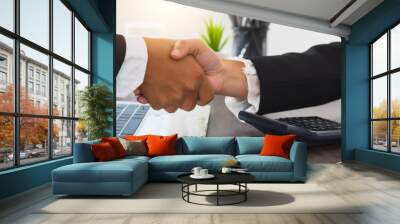 successful contract negotiate and handshake concept, two businessman shake hand with partner to celebration partnership, teamwork, business deal in room meeting after success communication, agreement Wall mural