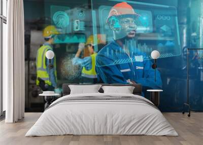 technology industrial African worker, electrical engineer looking and check on high techno screen monitor computer and machinery working in industry, metaverse machine engine concept Wall mural