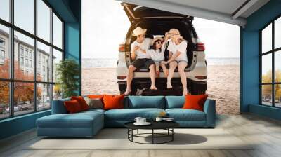 Family with Car travel driving road trip summer vacation in car in the sunset, Dad, mom and daughter happy traveling enjoy holidays and relaxation together get the atmosphere and go to destination Wall mural