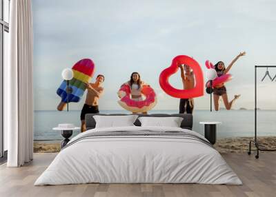 Group friends jumping enjoy life playing and freedom beach at sunset, Attractive together of asian male and female traveler with friends people lifestyle. Wall mural