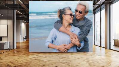 Happy asian couple senior elderly retirement resting at beach honeymoon family together happiness people lifestyle, copy space the left Wall mural