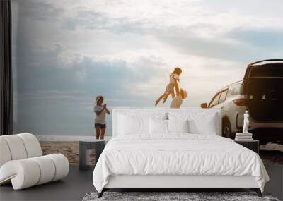 Happy Family with car travel road trip. summer vacation in car in the sunset, Dad, mom and daughter happy traveling enjoy together driving in holidays, people lifestyle ride by automobile. Wall mural