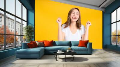 Portrait happy young asian woman dancing music celebrate fun enjoyment relaxation smiling positive emotion in white t-shirt, Yellow background isolated studio shot and copy space, party concept. Wall mural