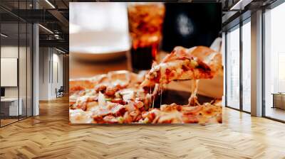 Slice of pizza cheese crust seafood topping sauce. with bell pepper vegetables delicious tasty fast food italian traditional and soft drink carbonated fresh on wooden board table classic in side view Wall mural