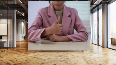 Successful Asian businesswoman sitting at desk working using laptop computer in office. Business and people concept. Businesswoman using laptop computer and working with documents. Wall mural