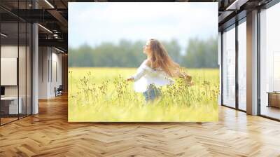 blonde with long hair in autumn field / concept of happiness health young adult model in summer landscape Wall mural