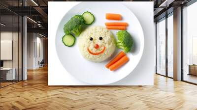 Funny food for children, cute rice with carrots and broccoli on a plate on a white background, a character with a smile and eyes Wall mural