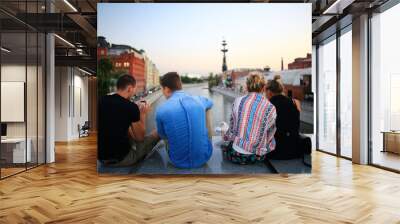 group of young people sitting relaxing in the industrial city Wall mural