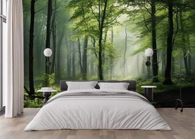 misty landscape in a fresh green spring forest,  trunks of green trees in the mist of the forest morning coolness Wall mural