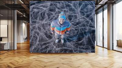 one guy skates on the ice of a frozen lake, nature landscape, man outdoor sports Wall mural