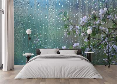 spring rain in the forest, fresh branches of a bud and young leaves with raindrops Wall mural