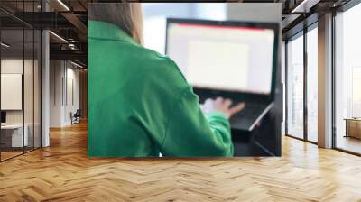 the girl is working at a laptop, the person is a woman of technology Wall mural