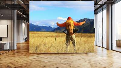 trekking mountains man walking sticks travel adventure man with backpack Wall mural