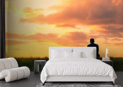 Alone man watching the sunset.  Wall mural