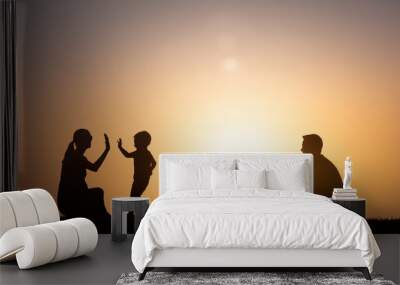 Family silhouette outdoors playing together.  Wall mural