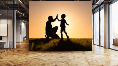 Father giving son high five. Parent child relationship concept  Wall mural