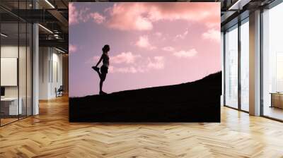 Female runner warming up outdoors. fitness active lifestyle concept.  Wall mural