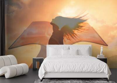 Hand holding bible and woman looking up to the sky .Religious freedom, and belief concept.  Wall mural