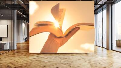 Hand holding bible. Religious belief concept. Wall mural