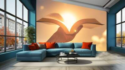 Hand holding open book bible up to the sunlight Wall mural