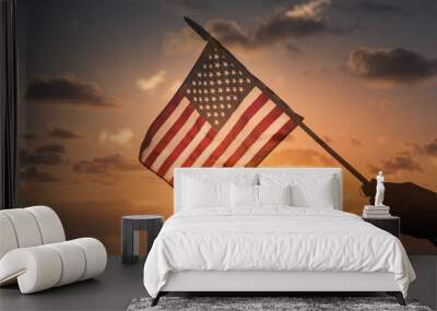 Hand holding USA American flag in the sky Wall mural