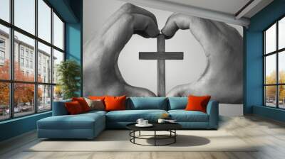 Hand making heart symbol with cross in the center. Religion concept.    Wall mural