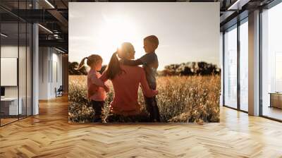 Happy single mother and her children in nature  Wall mural