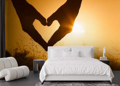 Heart against beautiful sunset. Wall mural