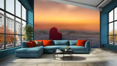 Heart close up against dramatic colorful ocean sunset sky 
 Wall mural