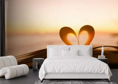 Heart from a book page against a beautiful sunset.
 Wall mural