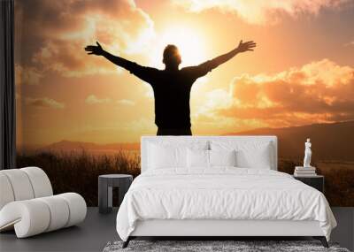 It's a beautiful life! Man standing in a field at sunset having feelings of freedom, hope, and happiness  Wall mural