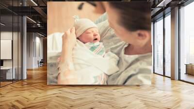 Mother holding new born baby boy in her arms. New life and giving birth concept.  Wall mural