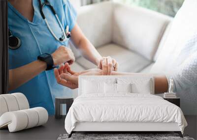 Nurse checking patient pulse  Wall mural