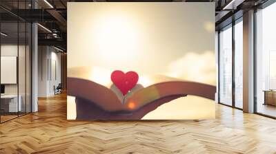 Open book with heart in the middle. religion, love and knowledge concept  Wall mural