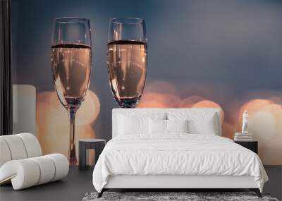 Pair of champaign glasses against beautiful city light bokeh. Wall mural