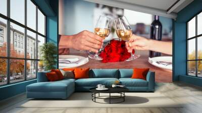 Romantic dinner table setup for couple. Man & Woman hold glass of wine. Concept for valentine's day and date Wall mural