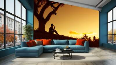 silhouette of man praying outdoors. Wall mural