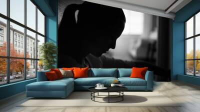 silhouette of sad woman home alone in a dark room  Wall mural