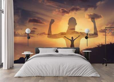 Strong confident woman flexing arms facing the sunset. People feeling inspire, and having inner strength concept.  Wall mural