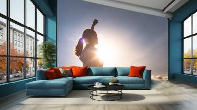 Strong young woman with fist up to the sky. Victory, and determination concept.  Wall mural