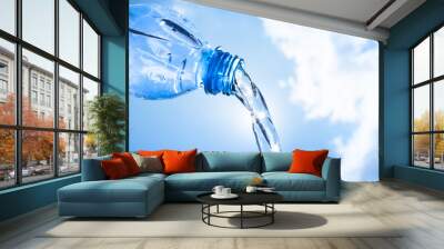 Water pouring from plastic bottle. Wall mural