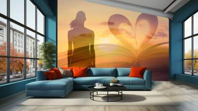 Woman standing next to book with heat shaped page. Spiritual, religious belief concept.  Wall mural