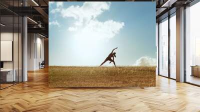 young female doing stretching exercises outdoors in a beautiful nature setting.  Wall mural