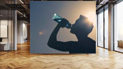 Young man drinking water.  Wall mural