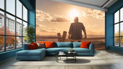 Young man sitting looking at the the beautiful view. Getting away from it all, people relaxing in nature concept.  Wall mural