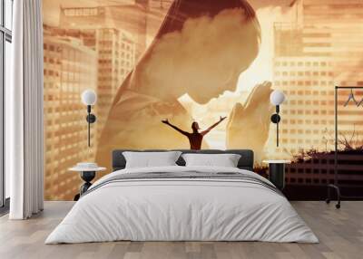 Young woman with praying hands worshiping in city, Religious belief concept.  Wall mural