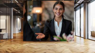  a smiling female hotel receptionist wearing a black suit and white shirt, greeting an array of guests dressed in different styles at the front desk in a luxury modern minimalist art deco style hotel  Wall mural