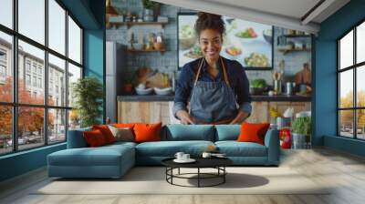 A black female chef stands in the kitchen, wearing an apron and smiling at the camera while cooking on the stove Wall mural