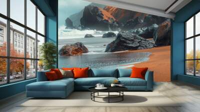 Black rocks on the beach, orange sand, blue sky, waves, misty sea Wall mural